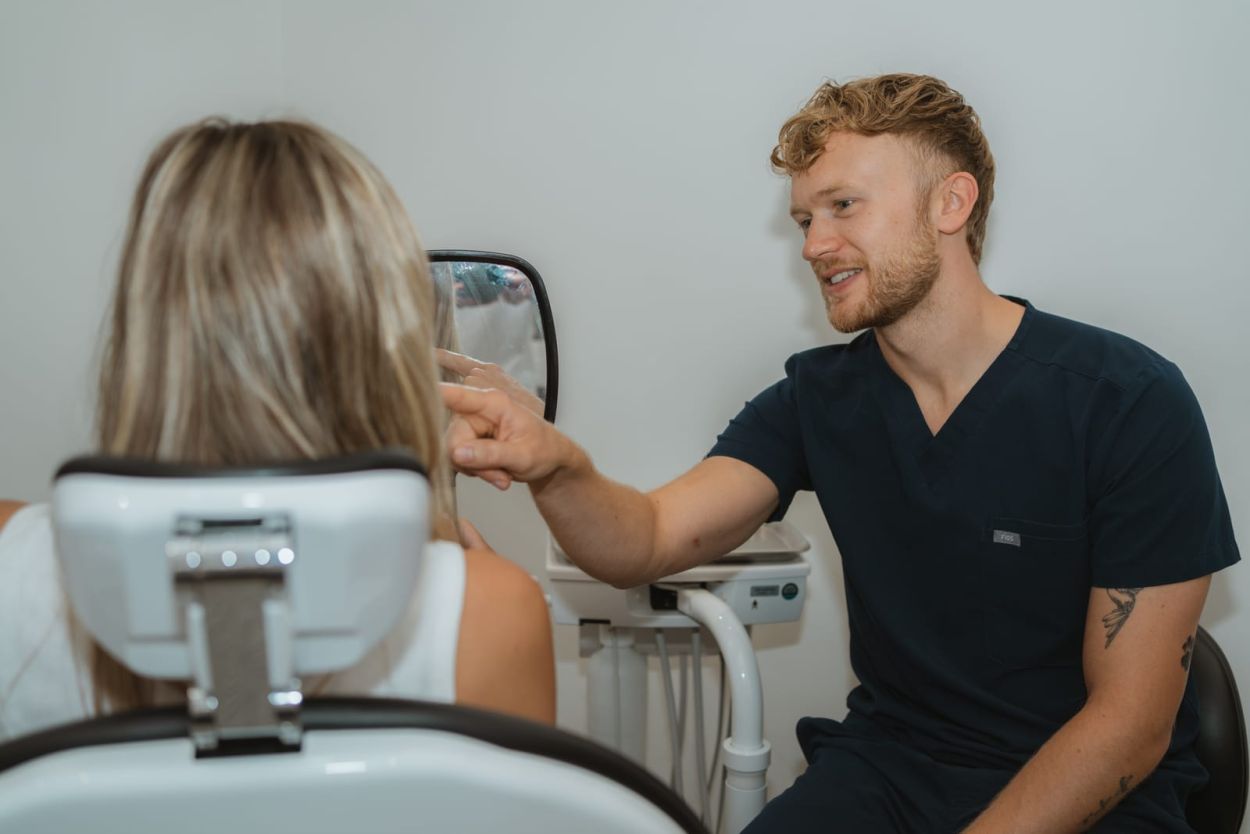 Dentist talking with a patient in the treatment room at Clowne Dental Practice